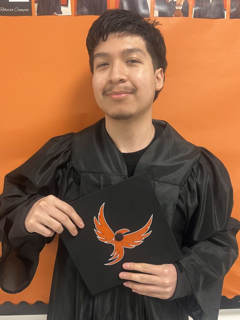 Student posing in graduation regalia