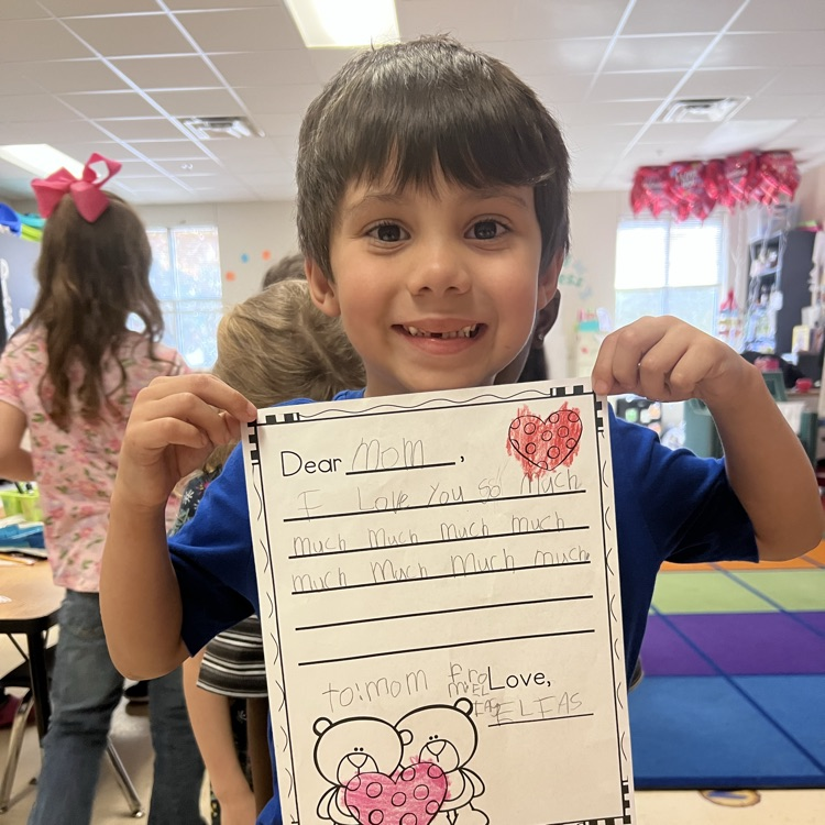 student displaying valentine writing