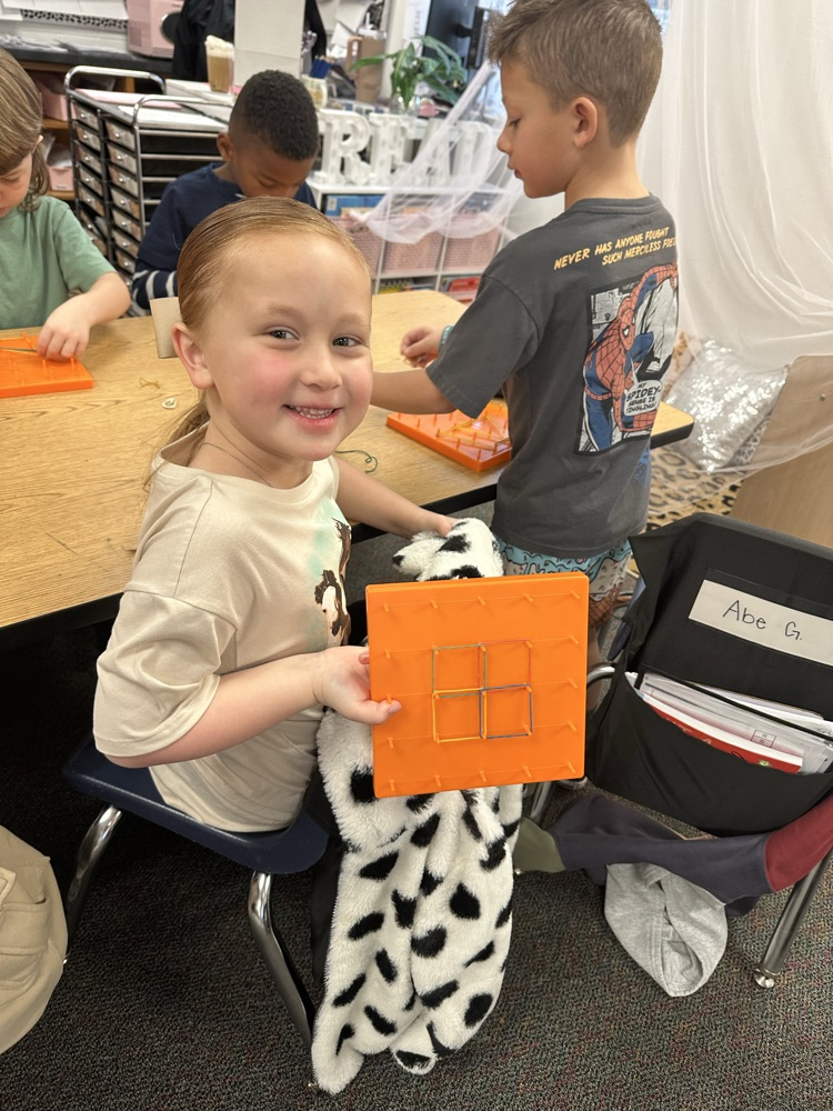 first graders using manipulatives to create 2d and 3D shape models