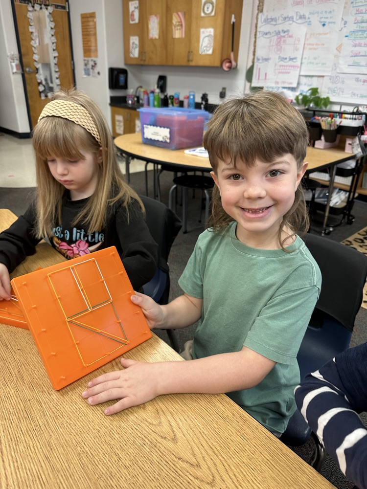 first graders using manipulatives to create 2d and 3D shape models