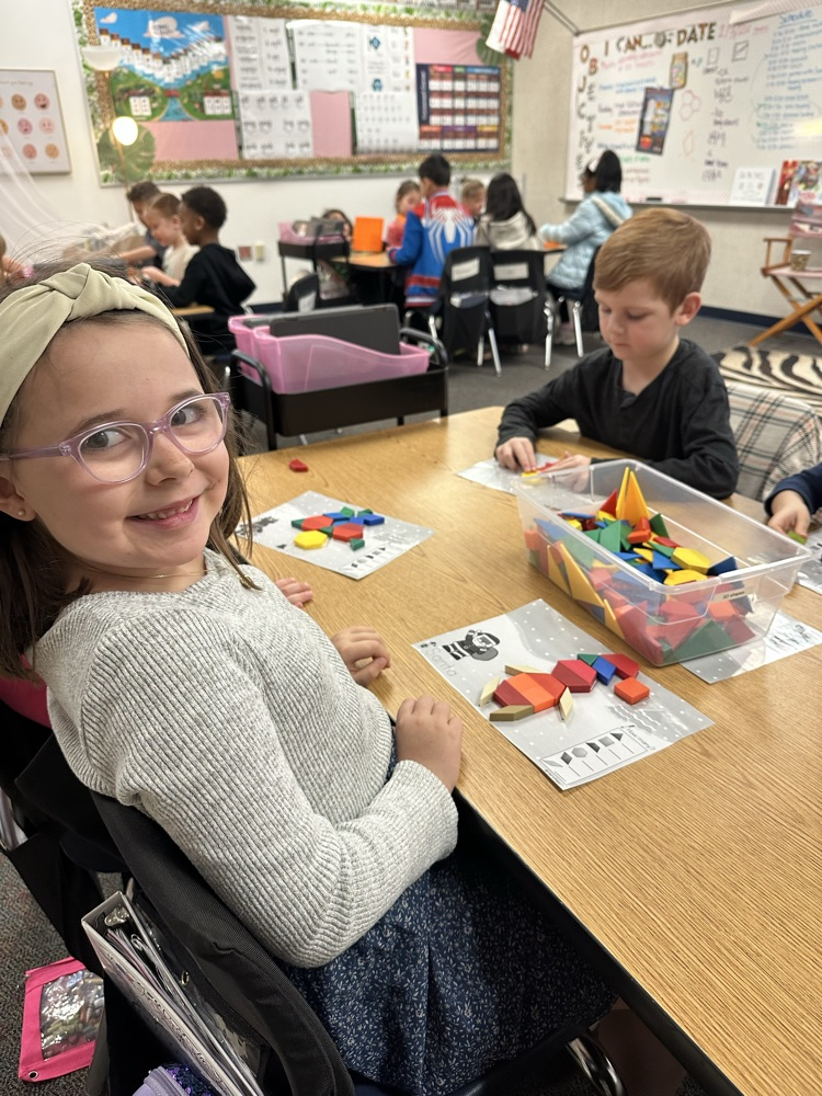first graders using manipulatives to create 2d and 3D shape models