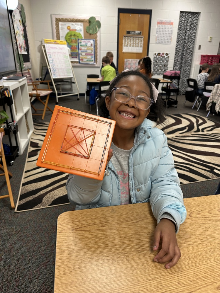 first graders using manipulatives to create 2d and 3D shape models