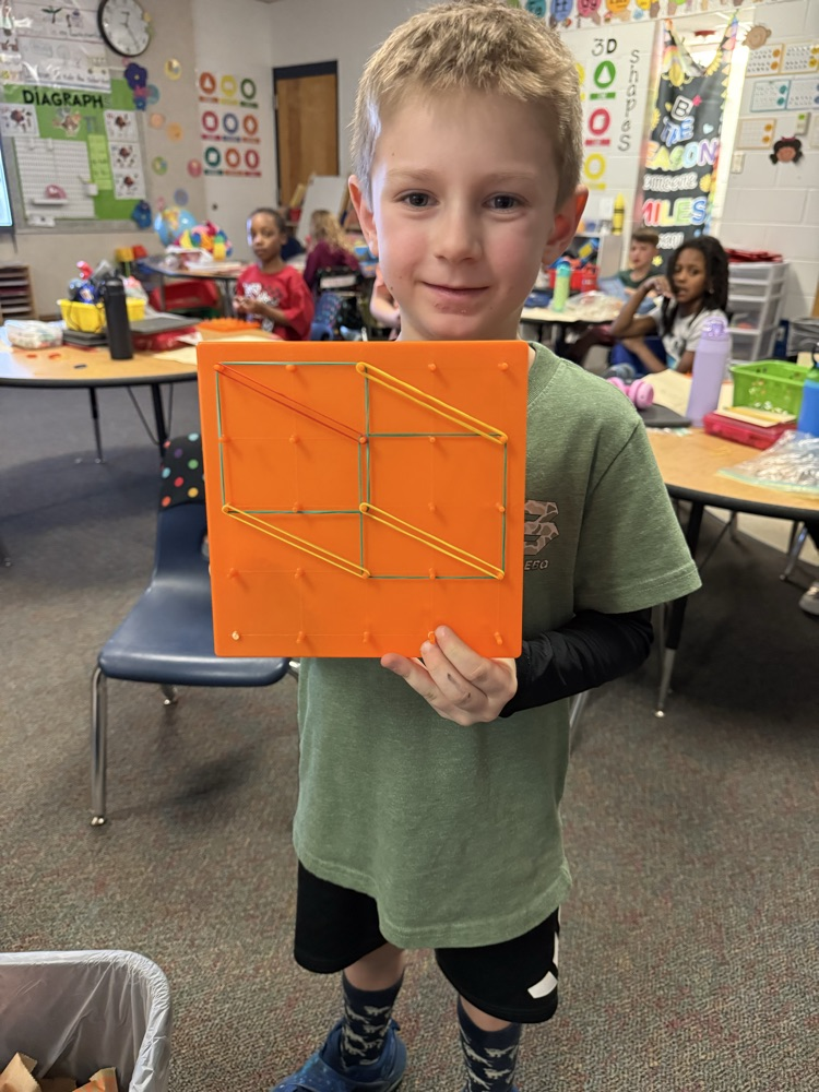 first graders using manipulatives to create 2d and 3D shape models