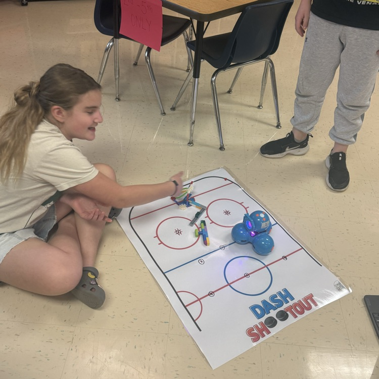 student coding a hockey robot