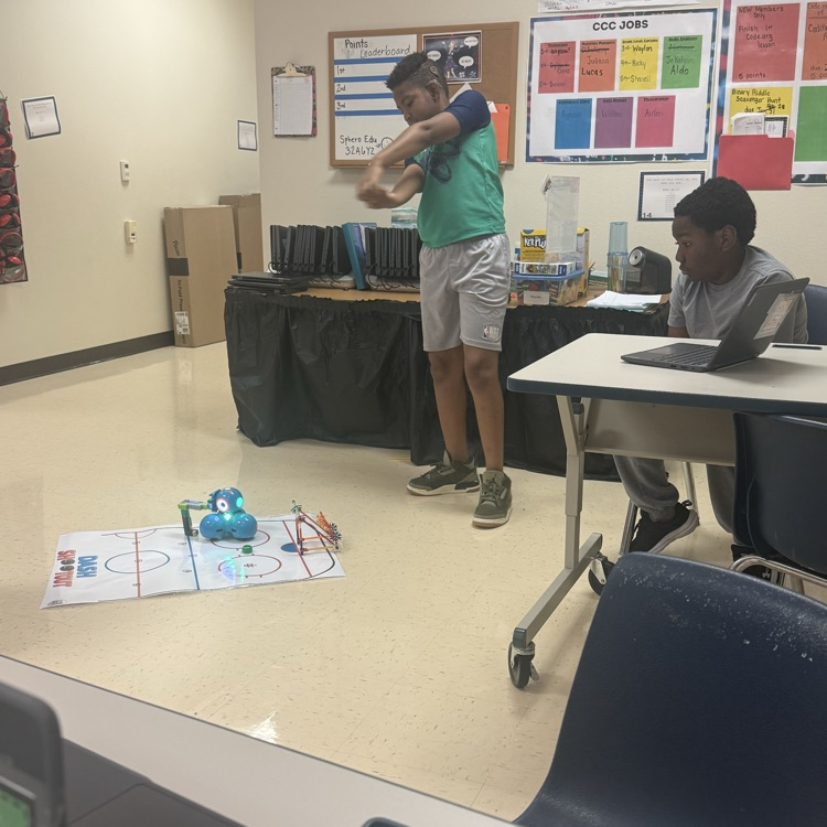 students coding a hockey robot