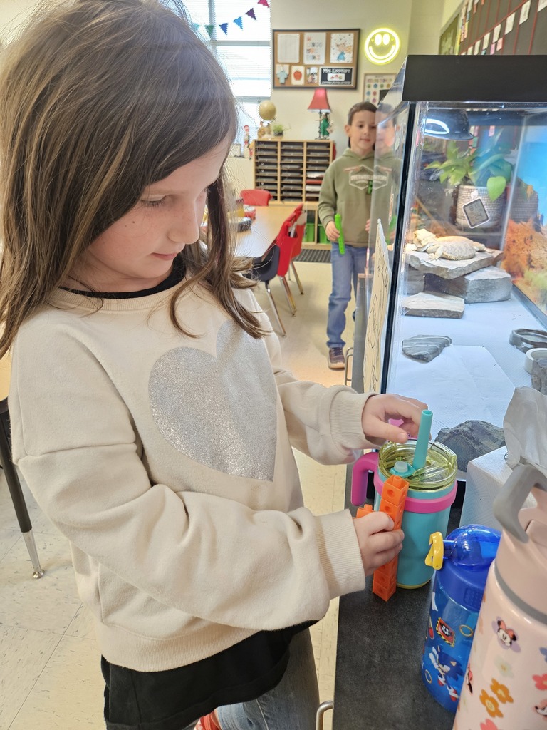 Kindergarten students using blocks to measure classroom items.