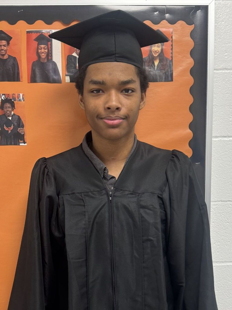 Student posing in graduation regalia