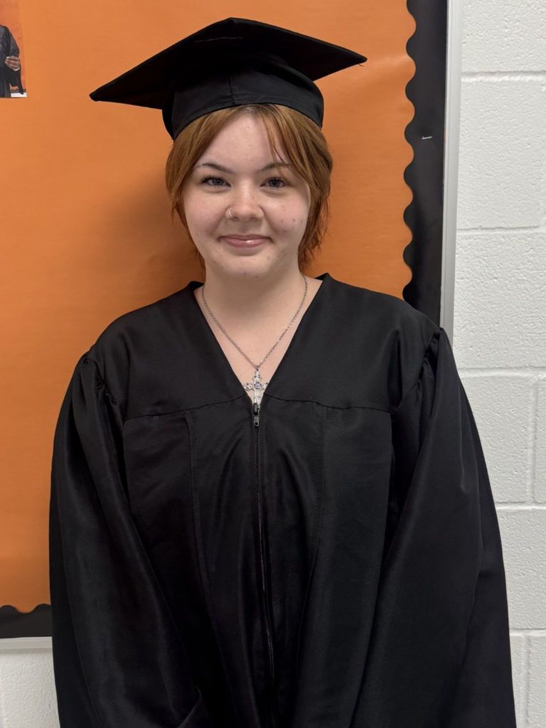 Student posing in graduation regalia