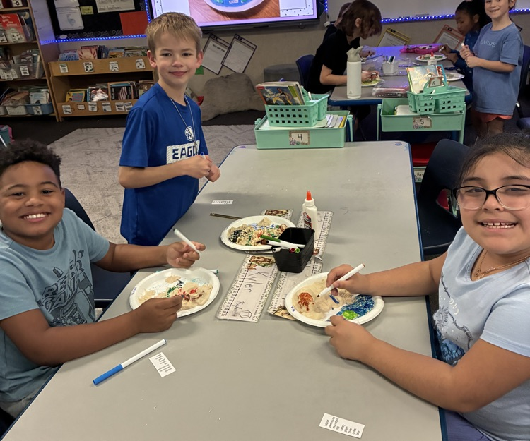 students showing off salt dough landforms 