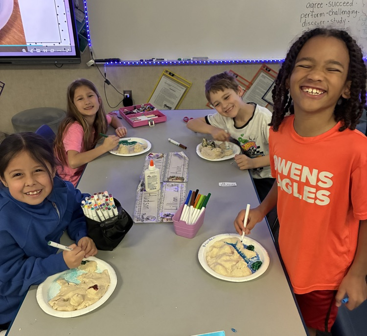 students showing off salt dough landforms 