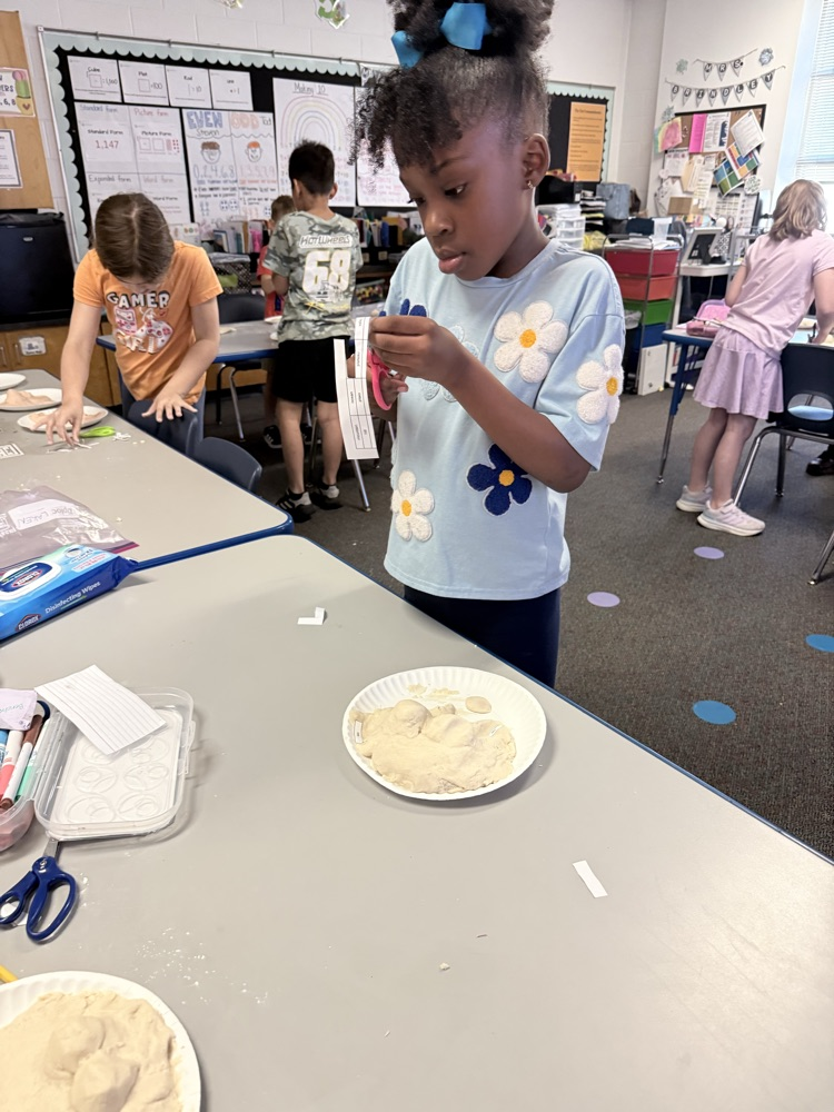 students showing off salt dough landforms 