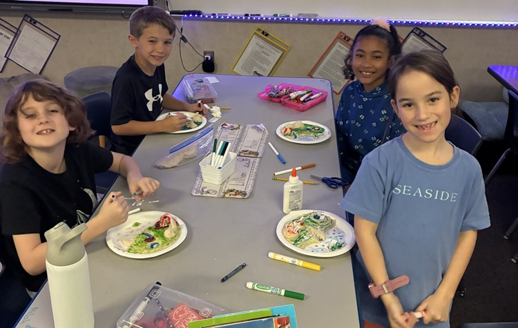 students showing off salt dough landforms 