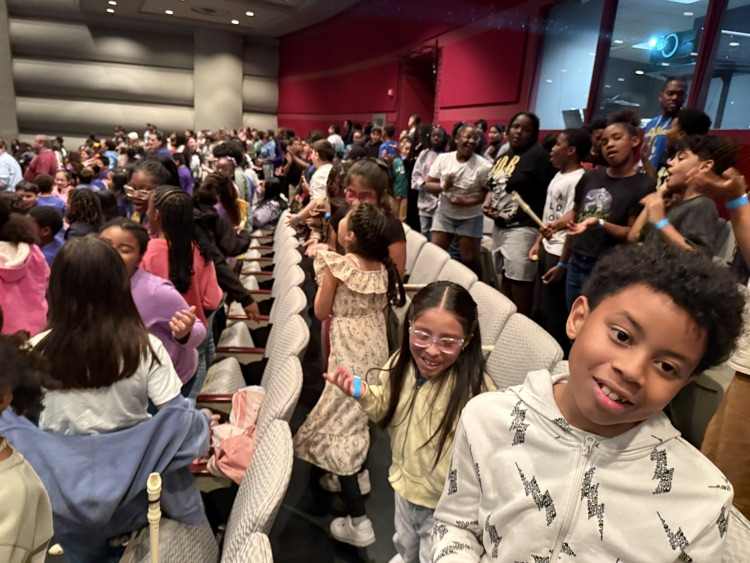 students singing and smiling