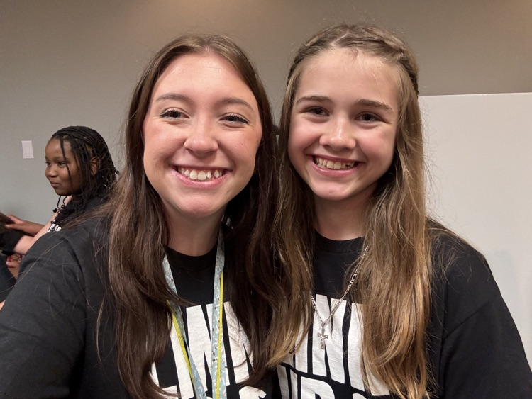 student and teacher smiling