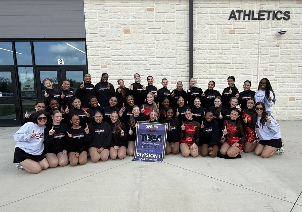 Tyler Legacy Southern Belle Drill team with their UIL DI banner 