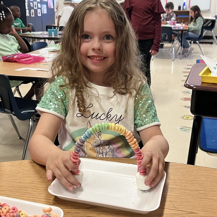 Student displaying the rainbow craft