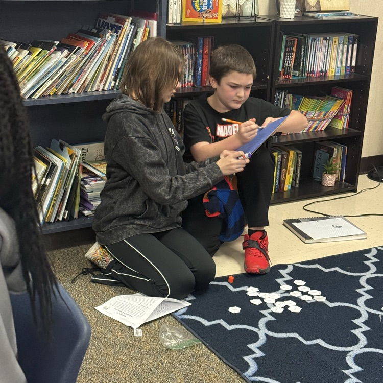 students working collaboratively on hexagonal activity