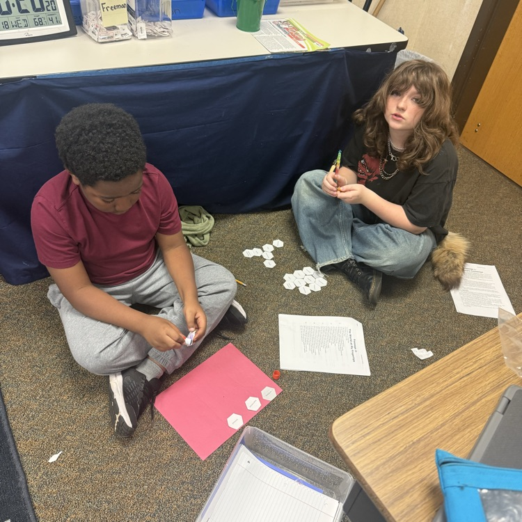 students working collaboratively on hexagonal activity