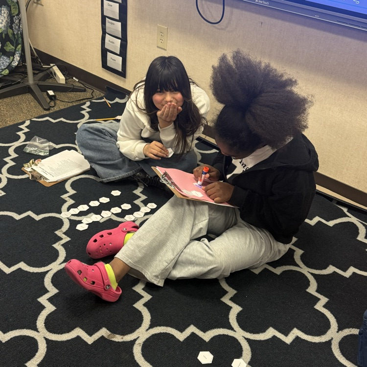 students working collaboratively on hexagonal activity