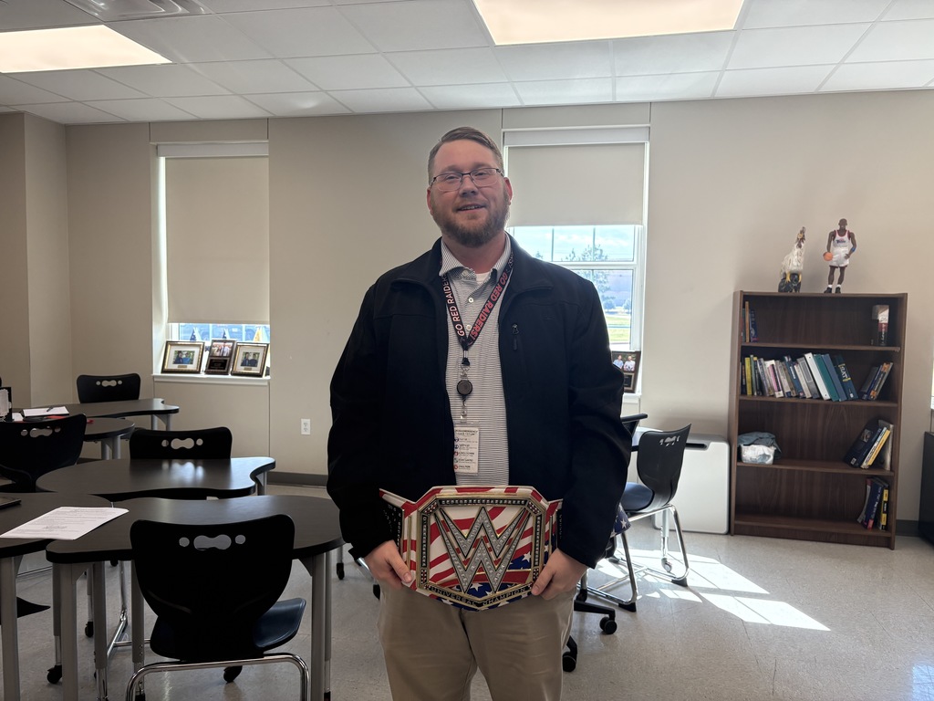 Tyler Legacy math teacher, Mr. Loeffler holding up the championship belt