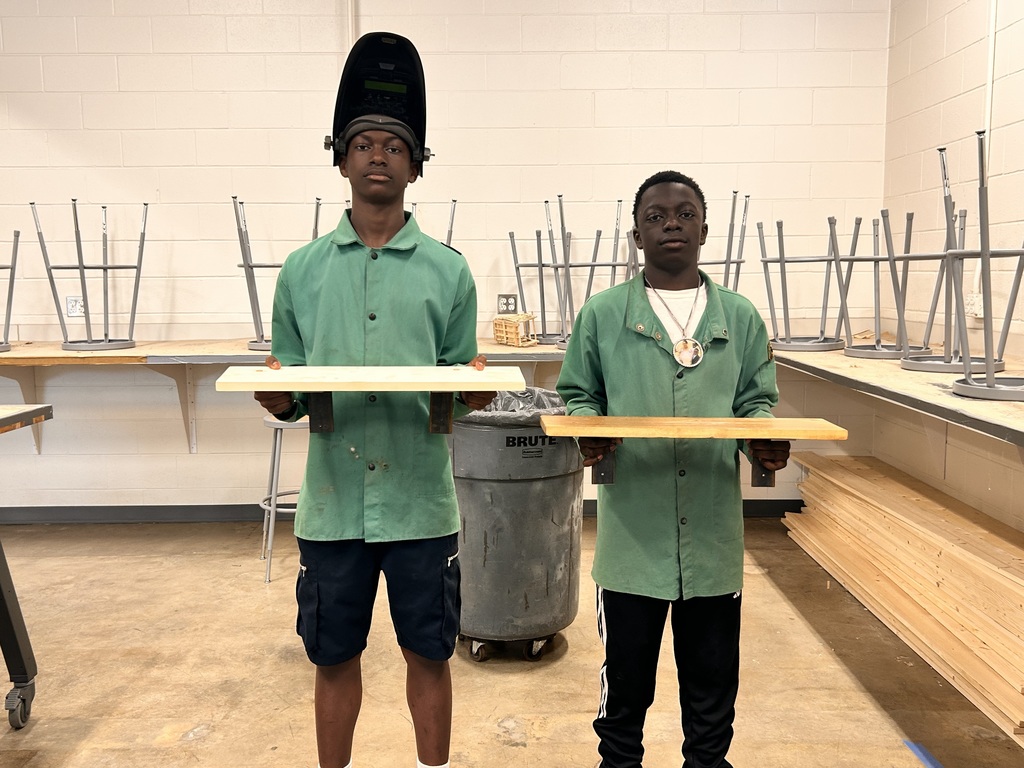 students holding their shelves