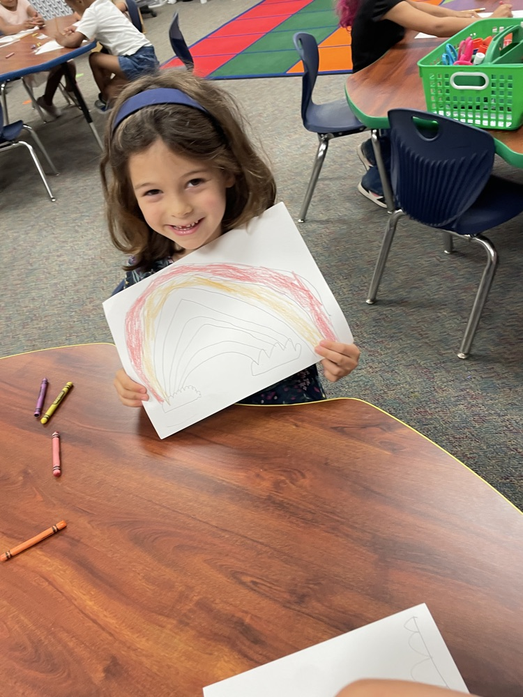 A kid doing rainbow activities  