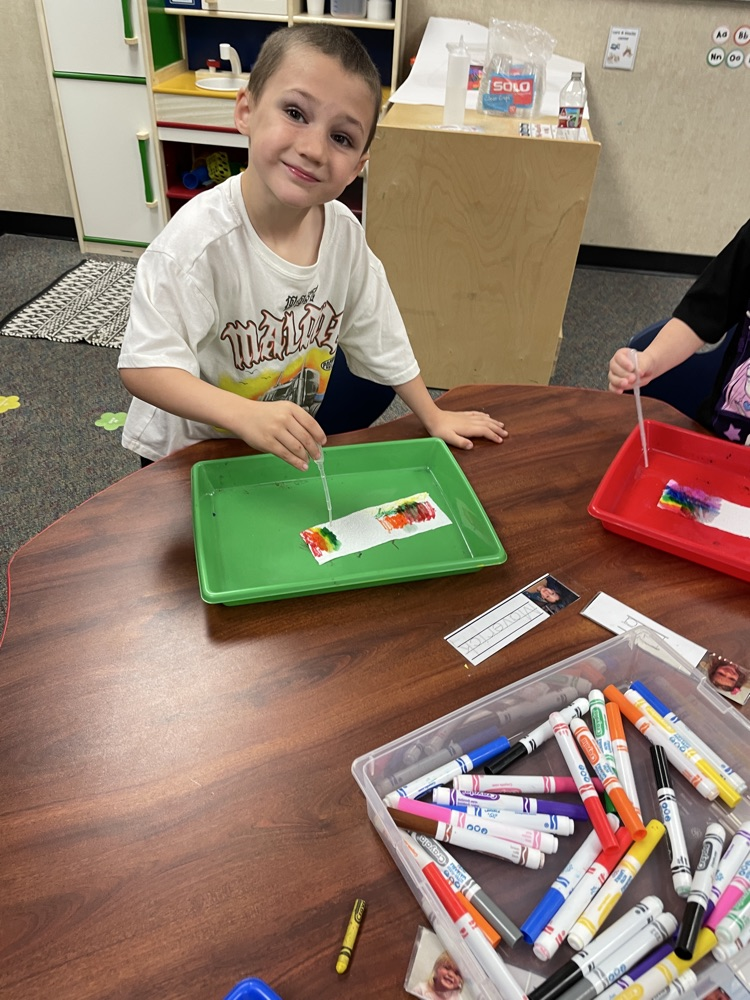 A kid doing rainbow activities. 