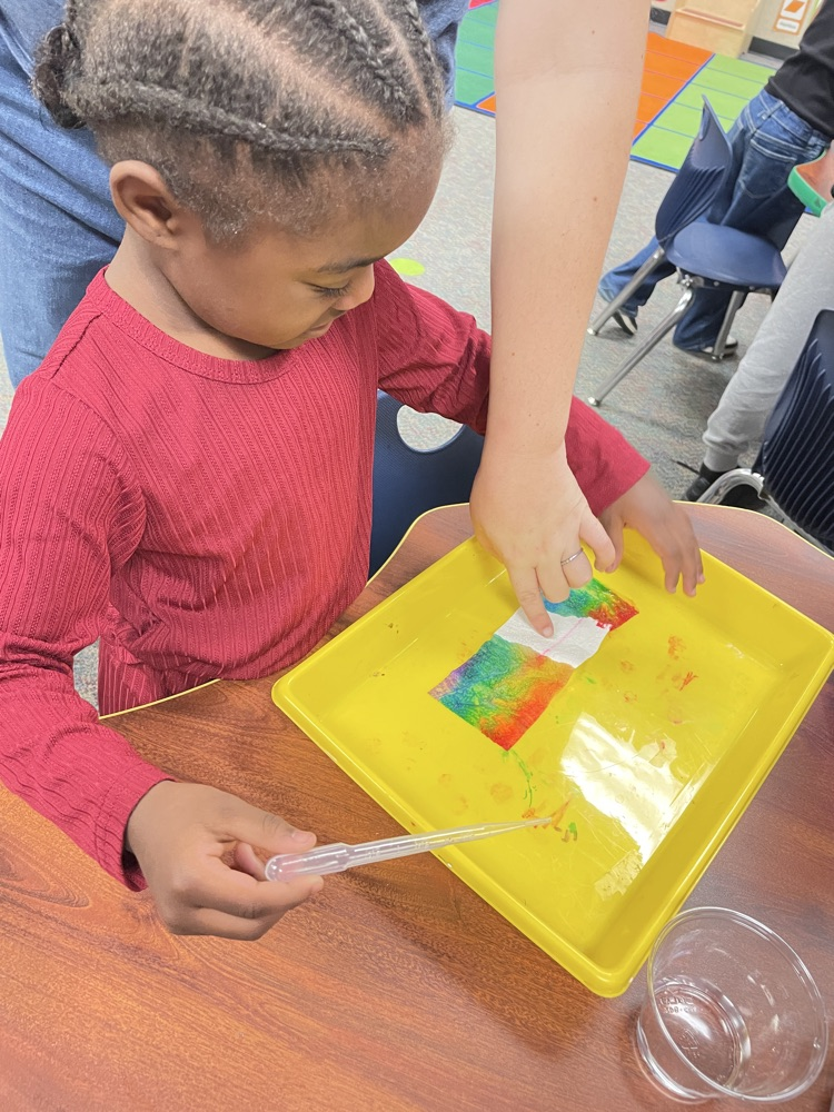 A kid doing rainbow activities. 