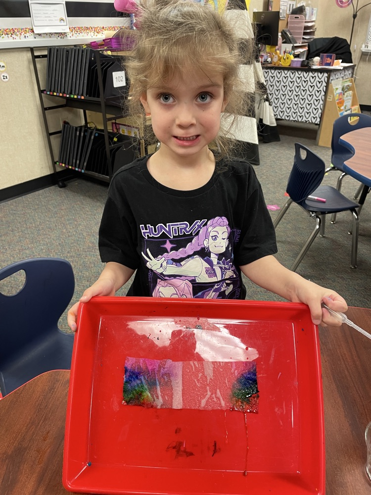 A kid doing rainbow activities. 