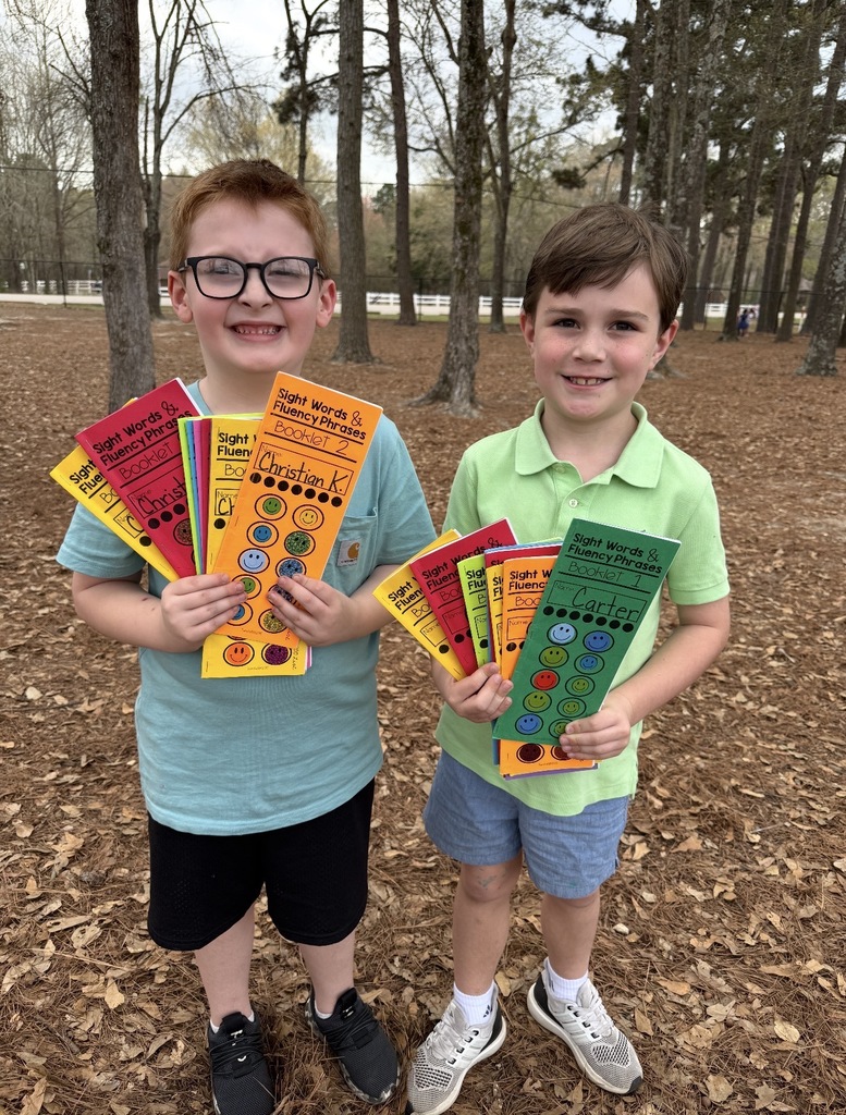 Students showing their completed sight word books.