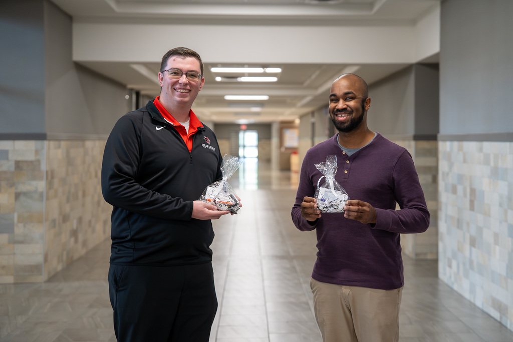 Legacy Music Teachers smilee while holding the WSL appreciation goodie bag.