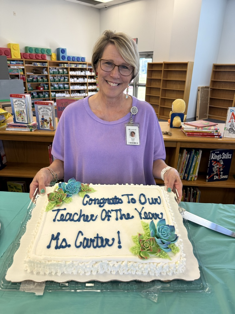 teacher of the year holding cake