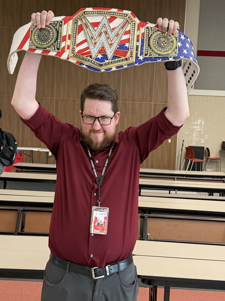 Mr. Bozeman holding up the Walk Through Wedenesday belt