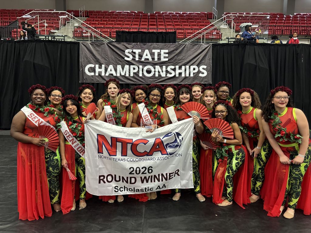 Tyler Legacy Varsity Winter Guard with their banner