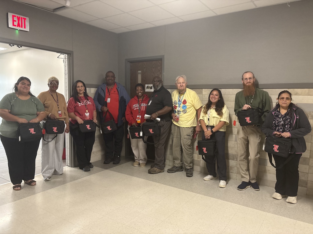 Some of Tyler Legacy's paraprofessionals with a TL lunchbox