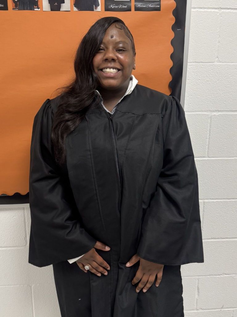 Student posing in graduation regalia