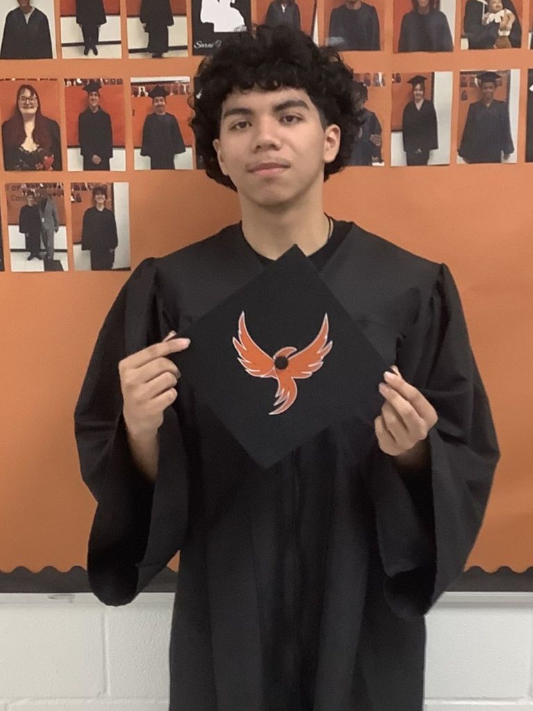 Student posing in graduation regalia