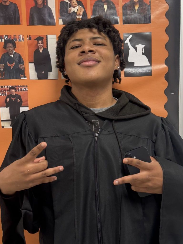 Student posing in graduation regalia