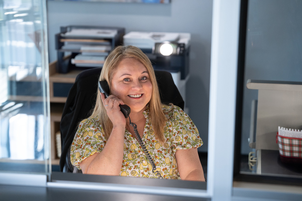 Tyler ISD Paraprofessional smiles while talking on the phone.