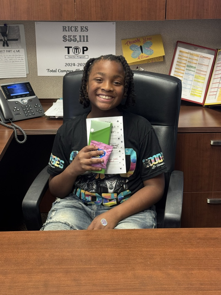 student in principal desk with rewards
