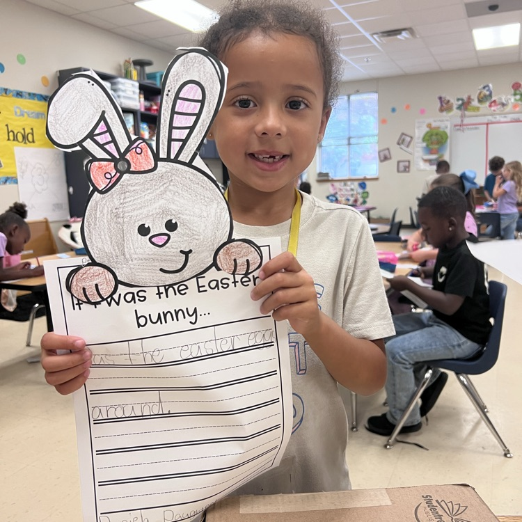 spring writing math activity. students holding up paper