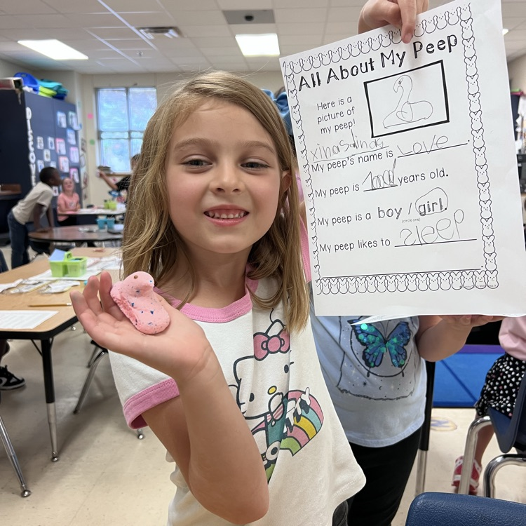 spring writing math activity. students holding up paper