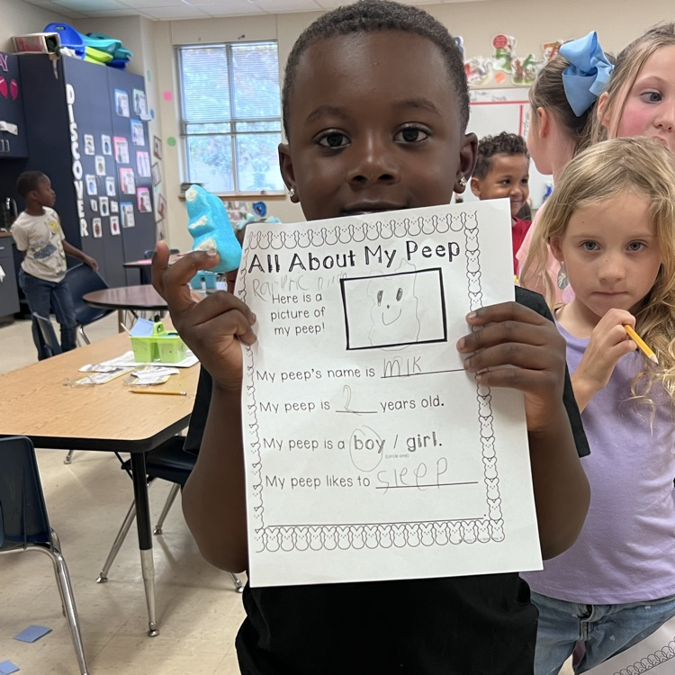 spring writing math activity. students holding up paper