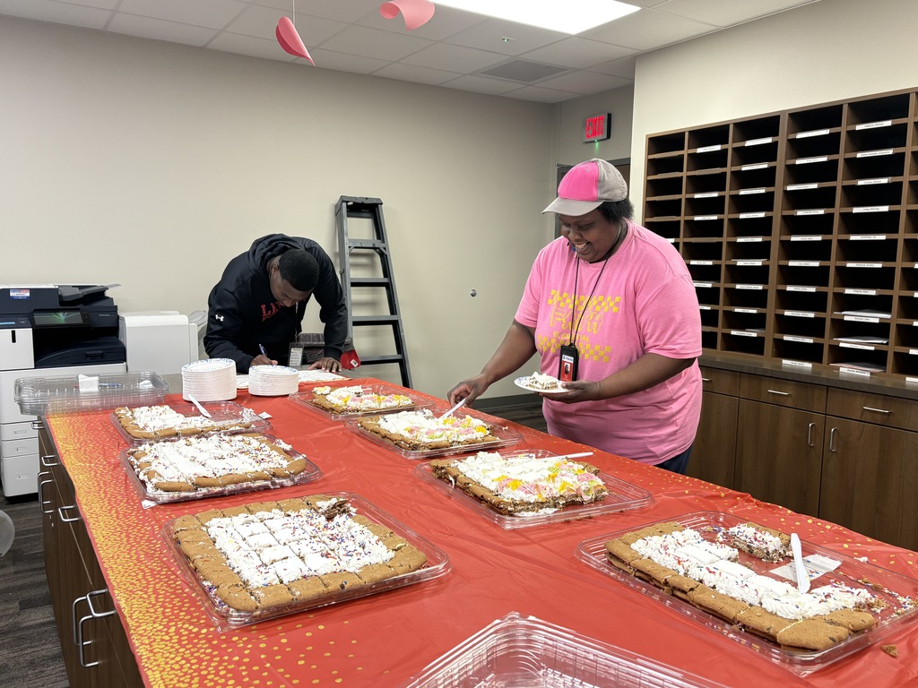 Staff members getting cookie cake for Mr. Sherman' birthday