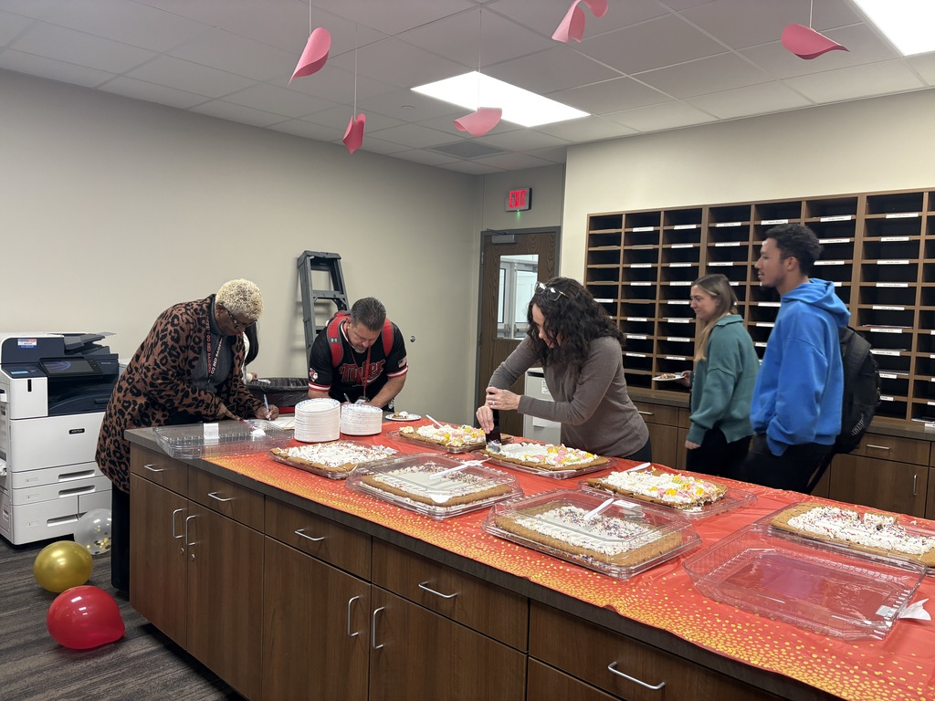 Staff members getting cookie cake for Mr. Sherman' birthday