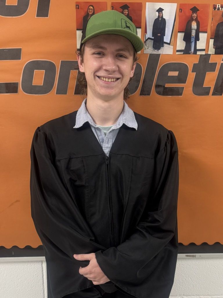 Student posing in graduation regalia
