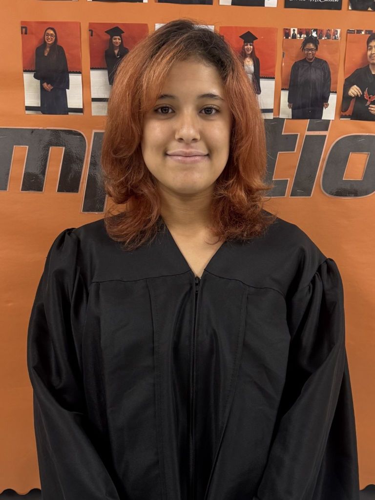 Student posing in graduation regalia
