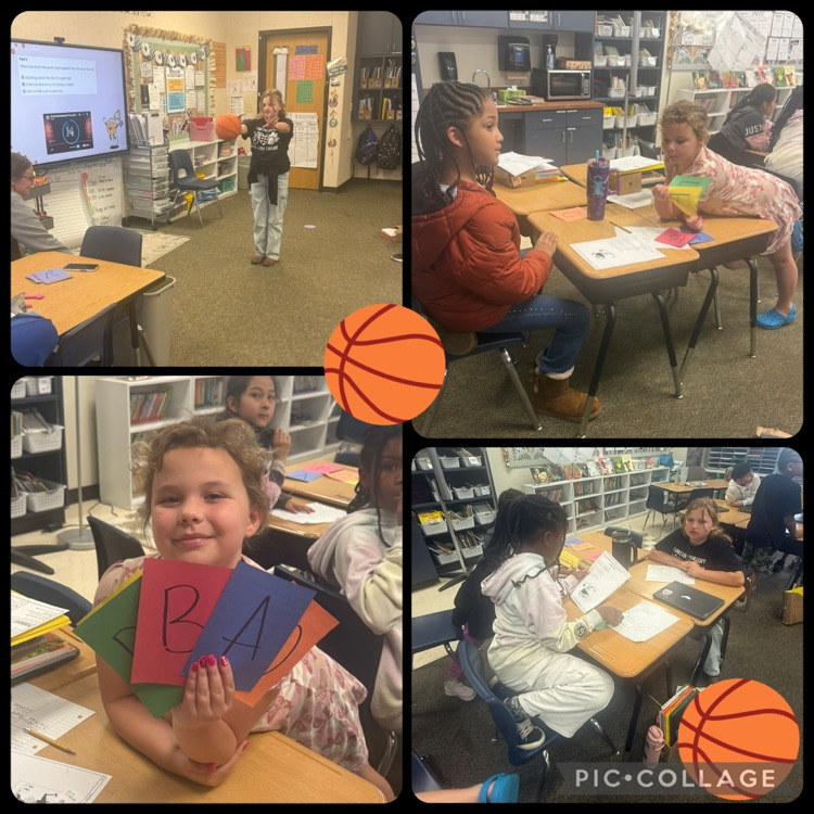 students playing trashketball. students working in groups and holding answer choice cards