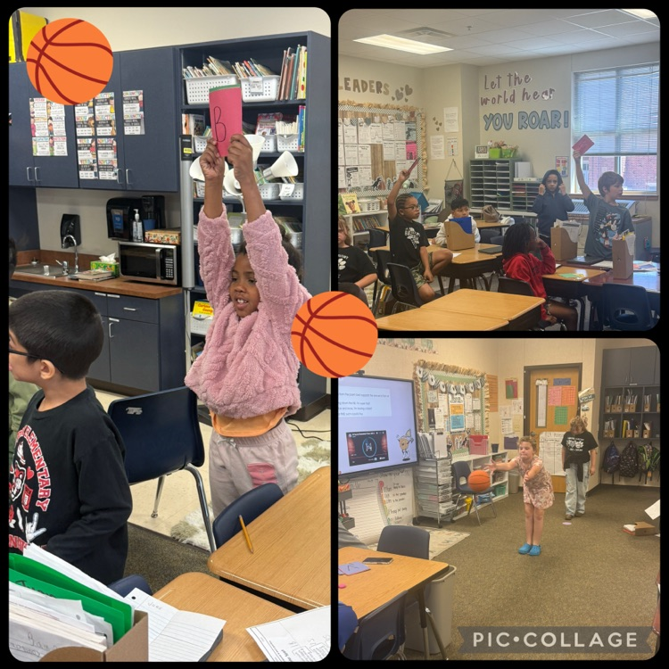 students playing trashketball. students working in groups and holding answer choice cards