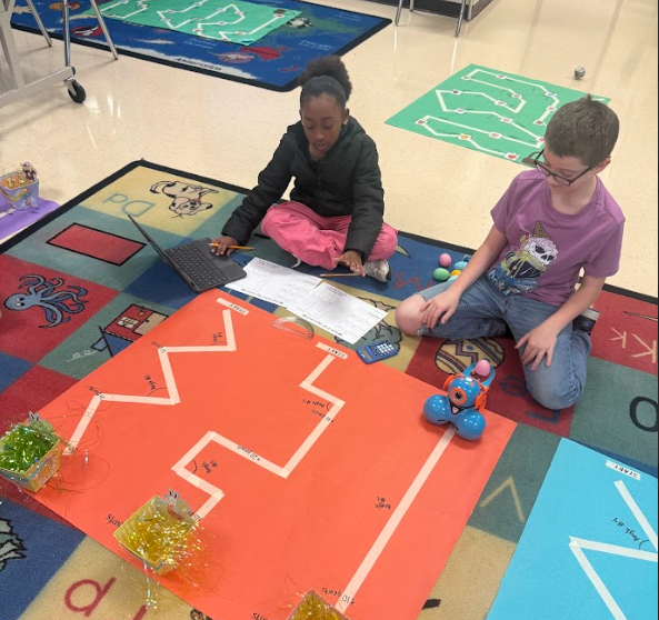 students coding robot to navigate down a path